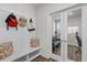 Mud room featuring built-in bench, coat hooks, and access to a private office space with French doors at 4011 Fallen Leaf Ct, Kennesaw, GA 30152