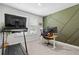 Well-lit office space equipped with a treadmill, multiple computer monitors and designer painted wall at 4011 Fallen Leaf Ct, Kennesaw, GA 30152