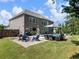 Expansive backyard with a luxurious pool, firepit, seating, and well-maintained lawn at 5220 Southern Hills Ln, Cumming, GA 30040