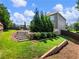 Multi-level backyard featuring green grass, landscaping, retaining walls, and stairs at 5220 Southern Hills Ln, Cumming, GA 30040