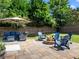 Cozy backyard patio with a fire pit and comfortable seating, perfect for entertaining at 5220 Southern Hills Ln, Cumming, GA 30040