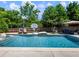 Stunning backyard pool with in-water loungers and ample shade, perfect for relaxation at 5220 Southern Hills Ln, Cumming, GA 30040