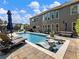 Luxury outdoor living space featuring a pristine pool with built-in loungers at 5220 Southern Hills Ln, Cumming, GA 30040