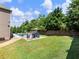 Sprawling backyard with green grass, landscaping, seating, and a built-in firepit at 5220 Southern Hills Ln, Cumming, GA 30040