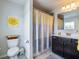 Bathroom with a toilet, shower with curtain, and dark vanity at 5220 Southern Hills Ln, Cumming, GA 30040