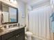 Clean bathroom featuring a granite countertop, modern fixtures, and a shower with curtain at 5220 Southern Hills Ln, Cumming, GA 30040
