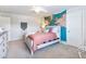 Bedroom featuring a light wood bed frame, and a map wall hanging at 5220 Southern Hills Ln, Cumming, GA 30040