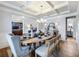 Formal dining area with coffered ceilings, wood floors, and a set dining table at 5220 Southern Hills Ln, Cumming, GA 30040