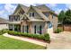 Two-story home with brick and siding, dark shutters, and a well-manicured lawn at 5220 Southern Hills Ln, Cumming, GA 30040