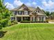 Beautiful brick and stone home with a well-manicured lawn and inviting curb appeal at 5220 Southern Hills Ln, Cumming, GA 30040