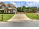 Charming two-story home featuring a stone facade and well-manicured lawn at 5220 Southern Hills Ln, Cumming, GA 30040