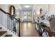 Inviting foyer featuring hardwood floors, staircase, and decorative furnishings at 5220 Southern Hills Ln, Cumming, GA 30040