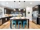 Kitchen with large island, stainless appliances, and wood floors at 5220 Southern Hills Ln, Cumming, GA 30040