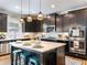 Kitchen with large island, stainless appliances, and modern pendant lighting at 5220 Southern Hills Ln, Cumming, GA 30040