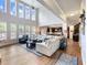 Open-concept living room with large windows, high ceilings, and hardwood floors at 5220 Southern Hills Ln, Cumming, GA 30040
