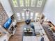 Bright living room featuring stone fireplace, many windows, and open floor plan at 5220 Southern Hills Ln, Cumming, GA 30040