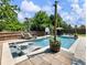 Relaxing backyard pool featuring a sun shelf with a lounge chair, a basketball hoop, and an umbrella at 5220 Southern Hills Ln, Cumming, GA 30040