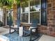 Inviting front porch with rocking chairs, a welcome sign, and brick accents at 5220 Southern Hills Ln, Cumming, GA 30040