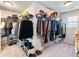 Large walk-in closet equipped with tiered shelving, hanging rods, and abundant storage options at 5220 Southern Hills Ln, Cumming, GA 30040