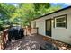 Charming back deck, perfect for outdoor dining and entertaining, surrounded by a lush, private backyard at 6090 Heritage Se Way, Mableton, GA 30126