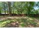 Large backyard offers ample space and a charming wooden fence, creating a private outdoor retreat at 6090 Heritage Se Way, Mableton, GA 30126