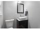 Modern powder room features floating vanity and ample light at 6090 Heritage Se Way, Mableton, GA 30126