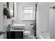 Modern bathroom featuring sleek vanity, stylish fixtures, and tub with tiled shower, combining comfort and elegance at 6090 Heritage Se Way, Mableton, GA 30126
