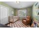 Cozy Bedroom with a crib, comfortable chair, and colorful bookshelves, creating a warm and inviting space at 6090 Heritage Se Way, Mableton, GA 30126