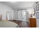 Well-lit bedroom shows wood floors with en suite bathroom separated by modern sliding door at 6090 Heritage Se Way, Mableton, GA 30126