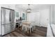 Bright dining area adjacent to kitchen with stainless steel refrigerator and hardwood floors at 6090 Heritage Se Way, Mableton, GA 30126