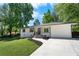 Beautifully renovated single-story home with a manicured lawn and a newly poured concrete driveway at 6090 Heritage Se Way, Mableton, GA 30126