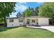 Charming home with white painted brick, dark trim, fresh landscaping, and a well-manicured lawn at 6090 Heritage Se Way, Mableton, GA 30126