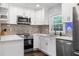 Well-lit kitchen with stainless steel appliances, granite countertops, and new white cabinetry at 6090 Heritage Se Way, Mableton, GA 30126