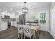 Bright kitchen features stainless steel appliances, white cabinets, and a dining nook with backyard access at 6090 Heritage Se Way, Mableton, GA 30126