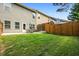 The backyard features a well maintained lawn and patio with an outdoor dining set at 881 Ash St, Canton, GA 30114