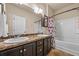 Bright bathroom featuring a double sink vanity, large mirror, and a shower/tub combo at 881 Ash St, Canton, GA 30114