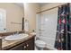 Well-lit bathroom featuring a shower-tub combo and granite vanity at 881 Ash St, Canton, GA 30114