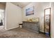 Hallway with a grey wood cabinet topped with decor pieces and an overhead light fixture at 881 Ash St, Canton, GA 30114