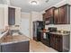Well-equipped kitchen featuring stainless steel appliances and beautiful dark wood cabinetry at 881 Ash St, Canton, GA 30114