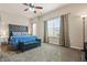 Spacious main bedroom with large windows, carpet flooring, and an overhead ceiling fan at 881 Ash St, Canton, GA 30114
