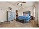 Carpeted main bedroom with a tufted headboard, bench at the foot of the bed, and a grey wood dresser at 881 Ash St, Canton, GA 30114