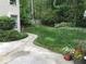 A lush, green backyard featuring a well-maintained lawn, landscaping, and a glimpse of a wooden fence at 1205 Rivershyre Ne Pkwy, Lawrenceville, GA 30043