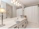 Bright bathroom with a white vanity, a large mirror, and white towels at 1205 Rivershyre Ne Pkwy, Lawrenceville, GA 30043