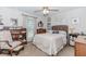 Bright bedroom with neutral tones, complemented by a plush chair, stylish decor, and natural light at 1205 Rivershyre Ne Pkwy, Lawrenceville, GA 30043