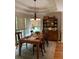 Elegant dining room showcasing a wooden dining table, chairs, a decorative hutch, and large windows with natural lighting at 1205 Rivershyre Ne Pkwy, Lawrenceville, GA 30043