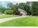 Suburban two-story house with a long driveway and large, well-manicured lawn at 1205 Rivershyre Ne Pkwy, Lawrenceville, GA 30043