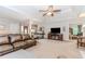 Open-concept living area featuring a spacious layout with a leather sofa, fireplace, and a view into other living spaces at 1205 Rivershyre Ne Pkwy, Lawrenceville, GA 30043