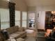 Bright living room featuring neutral decor, plush seating, and large windows offering natural light and a view of outdoors at 1205 Rivershyre Ne Pkwy, Lawrenceville, GA 30043
