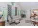 Bright living room with large windows, plush seating, and elegant decor at 1205 Rivershyre Ne Pkwy, Lawrenceville, GA 30043