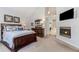 This bedroom features a decorative fireplace, vaulted ceilings, and neutral-colored carpet at 1205 Rivershyre Ne Pkwy, Lawrenceville, GA 30043